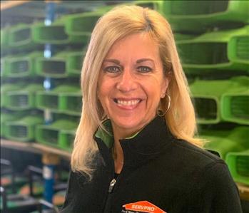Female in front of SERVPRO equipment
